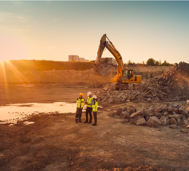 Construction site at sunset with excavator.