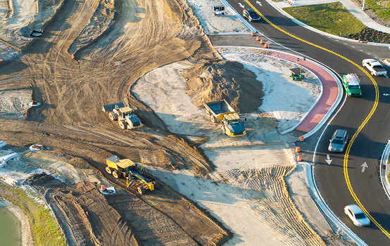 Road construction site with heavy machinery.